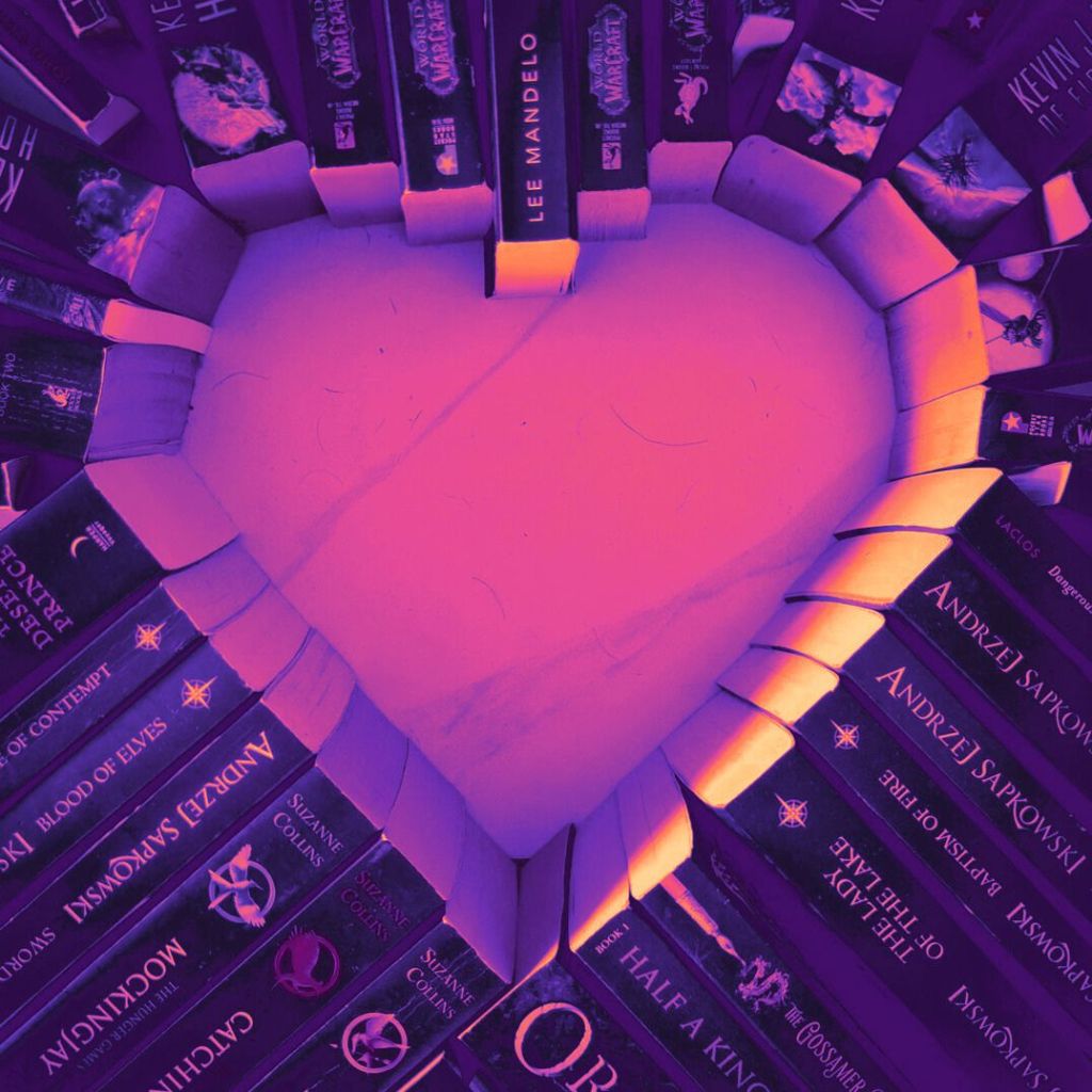 books arranged in a heart with warm colours